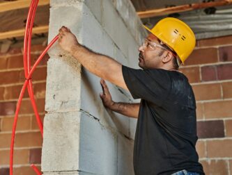 Commercial electrician inspecting electrical code violations for an Orange County property.