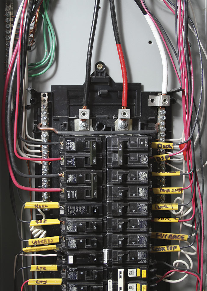 Electrician installing new grounded copper branch circuit wiring during a knob and tube wiring replacement