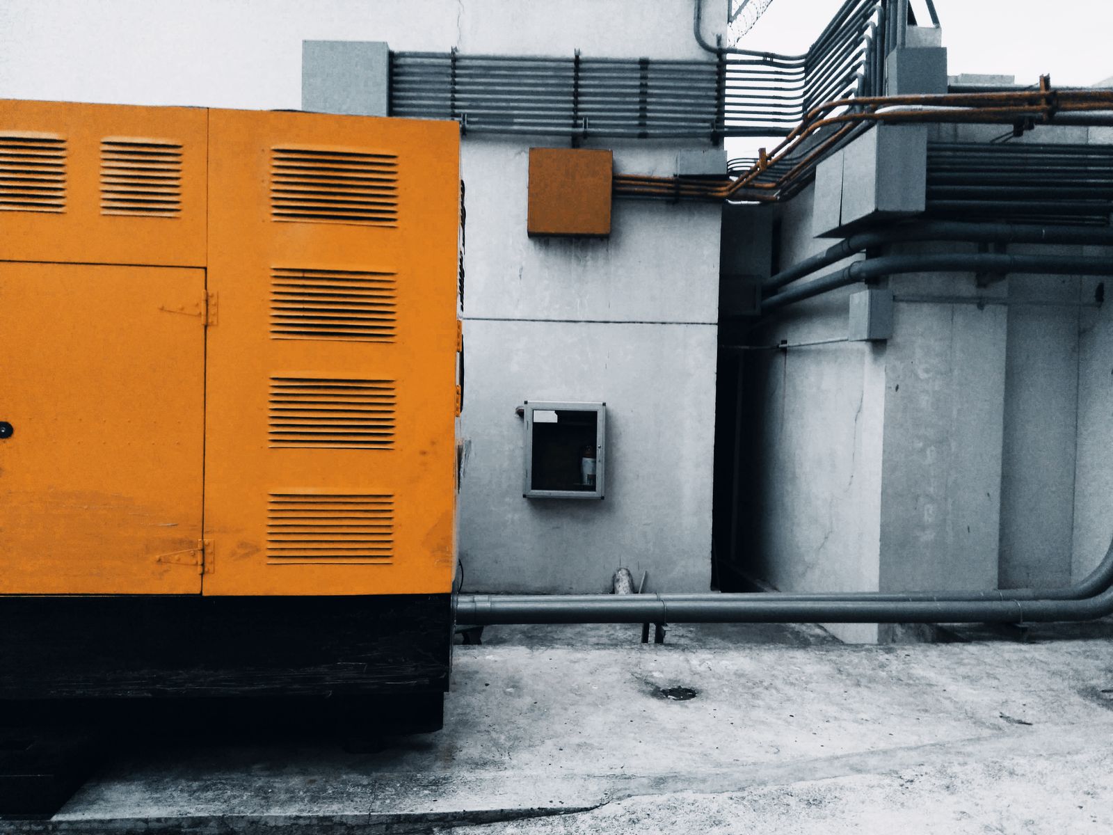 Enclosed standby generator installed outdoors beside a building